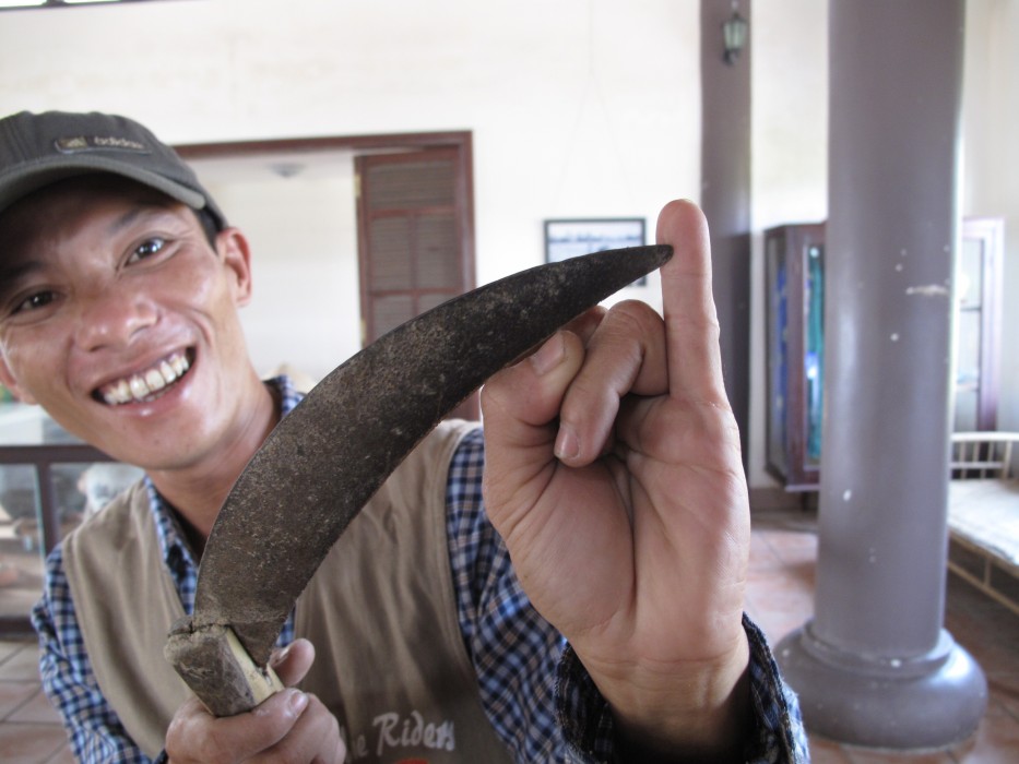 Quy, displaying his scar from harvesting rice.